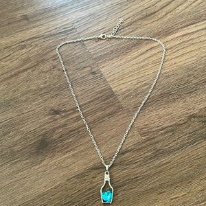 Stainless silver women necklace with a bottle Pendant and aqua blue heart